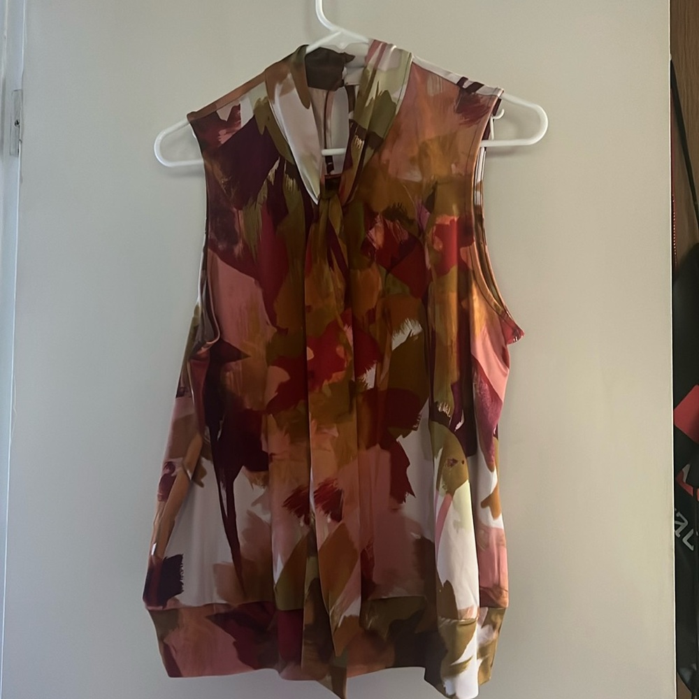 Beautiful sleeveless summer blouse could be also used in fall unders suits
